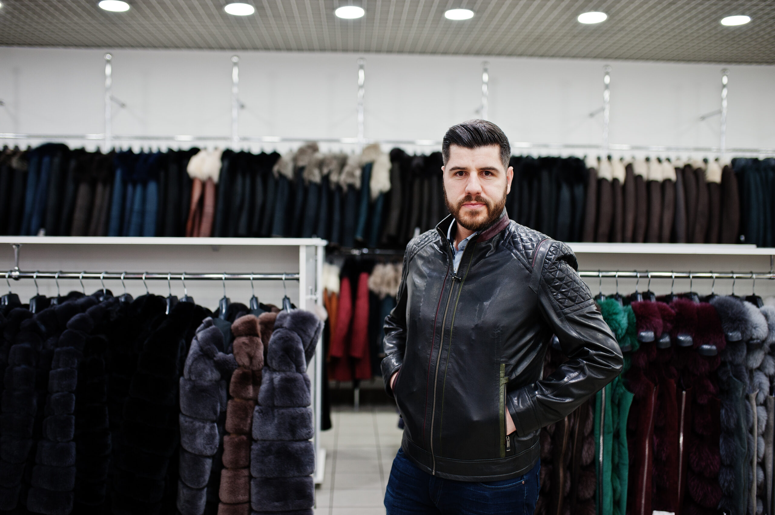 Stylish turkish man at the store of fur coats and leather jacket